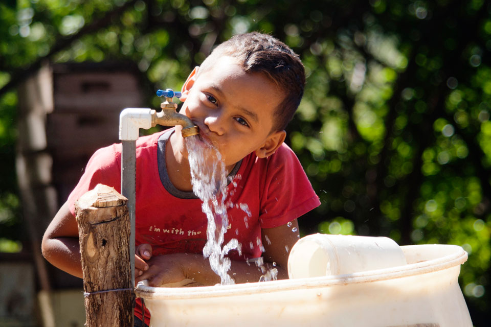 Child drinking water from the tap in Nicaragua