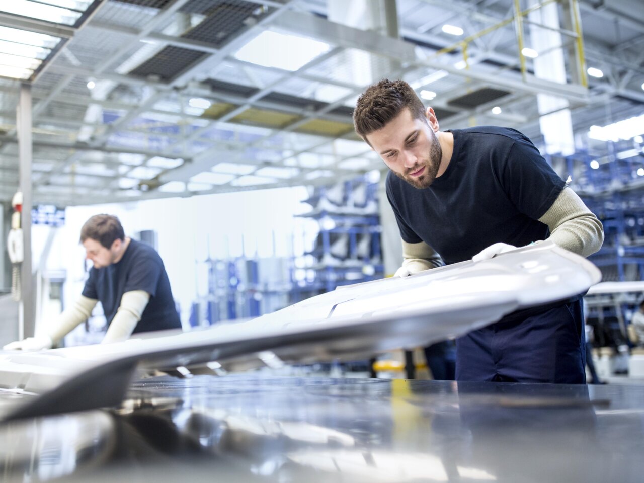 Two men working in a factory Two men working in a factory